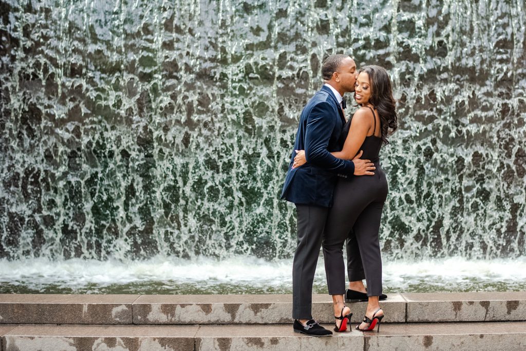 kissing by waterfall first wedding anniversary session in Washington DC