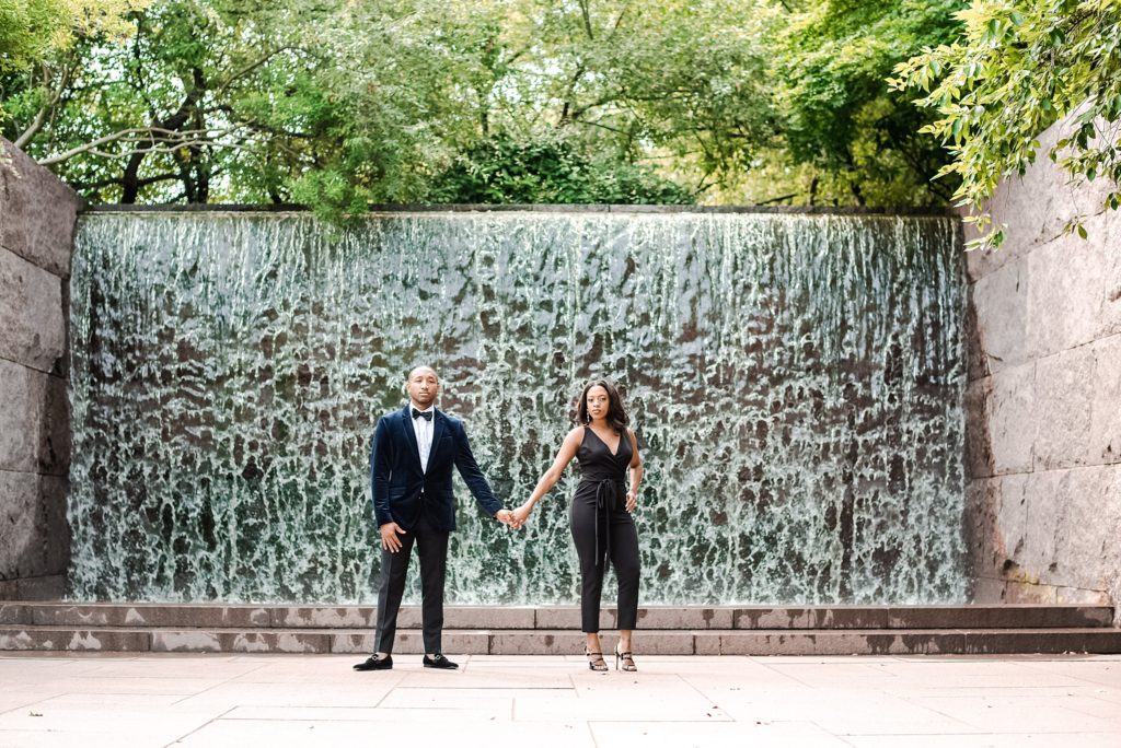 Holding hands by fountain first wedding anniversary session in Washington DC